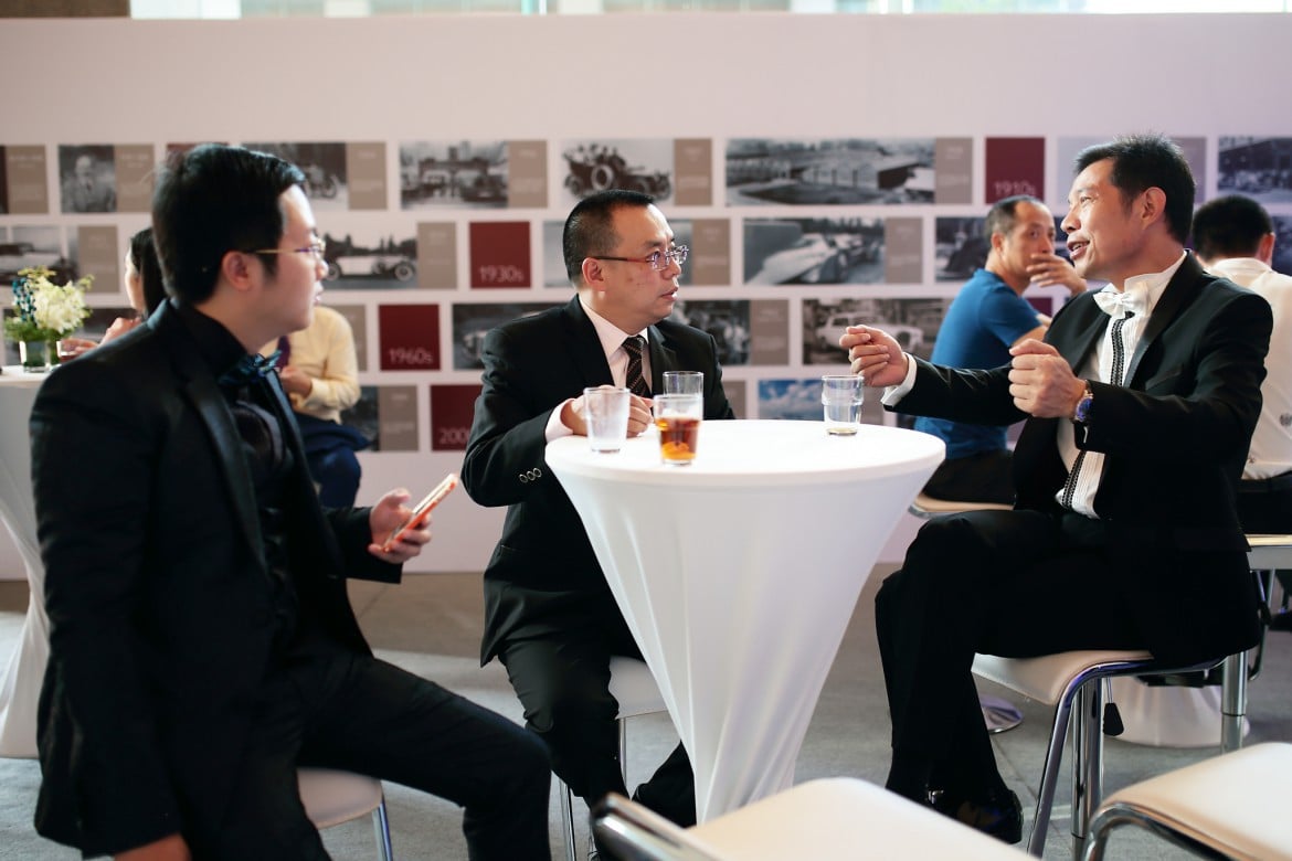 The Rolls-Royce enthusiasts interacting with one another at the Rolls-Royce Masterpiece Series Exhibition